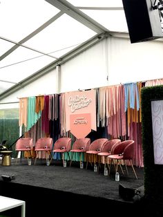 chairs are lined up on the stage for an event