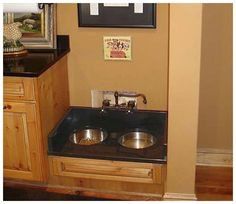 a kitchen sink with two bowls on the counter