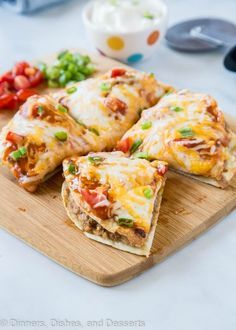 several quesadillas on a wooden cutting board