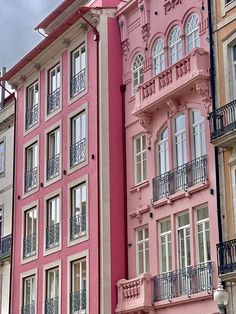 a large pink building with balconies and windows