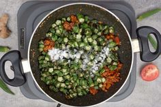 a pan filled with vegetables on top of a stove