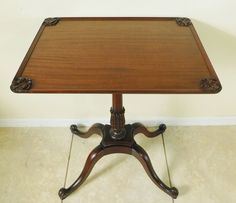 a wooden table sitting on top of a tile floor