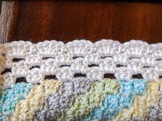 a close up of a crocheted blanket on a table