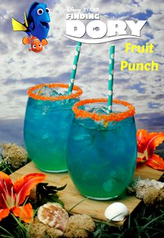 two glasses filled with blue liquid and orange straws