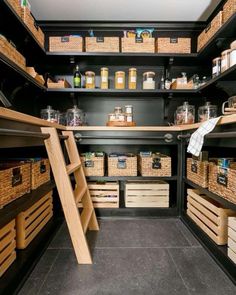 an organized pantry with wooden shelves and wicker baskets