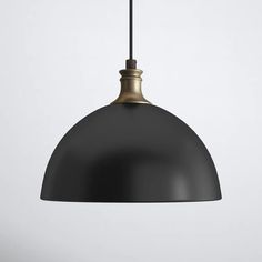 a black and gold pendant light hanging from a ceiling