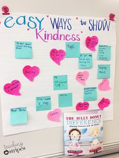 a bulletin board with pink and blue paper hearts attached to it's sides, next to a book titled easy ways to show kindness