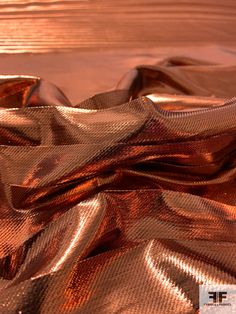 a close up of a shiny cloth on a wooden surface