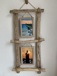 two wooden frames hanging on the wall next to each other with lighthouses in them