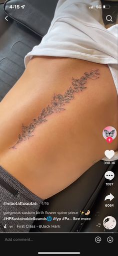 the back of a woman's stomach with flowers on it