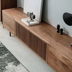 a wooden entertainment center with two speakers on it