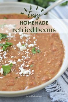 a white bowl filled with homemade refried beans and topped with parmesan cheese