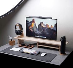 a flat screen tv sitting on top of a wooden stand next to a keyboard and mouse