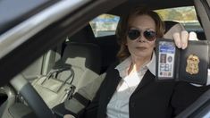 a woman sitting in the back seat of a car