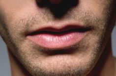 a close up of a man's lips and nose