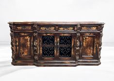 an old wooden cabinet with ornate carvings on the front and sides, against a white background