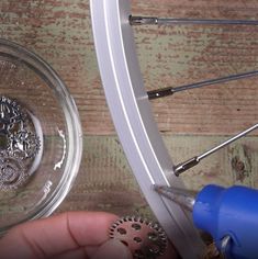 someone is working on the spokes of a bicycle wheel with a screwdriver