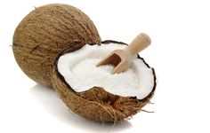 a whole coconut with a wooden spoon in it