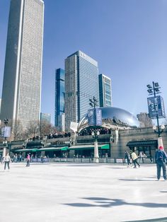 people skating on an ice rink in the city