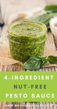 a jar filled with pesto sitting on top of a wooden table