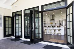 an open door leading into a kitchen and dining room