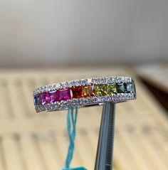 Genuine Fancy color sapphire and diamond ring. This lucky rainbow ring will cheer and brighten anyone's day. Excellent quality gems. The color of these sapphires are rich and vibrant. All Genuine stones. Good for everyday wear, all stones are set smooth; won't catch on things. Please order 1/4 size bigger for comfortable fit. This is a solid band. All sapphires are diamond cut princes cut stones total weight: 0.93 carats Genuine round brilliant cut diamonds total weight: 0.23 carats Clarity: SI1 Rainbow Sapphire Anniversary Ring Fine Jewelry, Rainbow Multi-stone Rings In 14k Gold, Rainbow Multi-stone Sapphire Jewelry, 14k Gold Rainbow Multi-stone Rings, Rainbow Multi-stone Cubic Zirconia Rings, Ombre Rings, Pear Halo, Flower Diamond Ring, Rainbow Sapphires