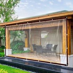 a covered patio area with chairs and table in the background, surrounded by green grass