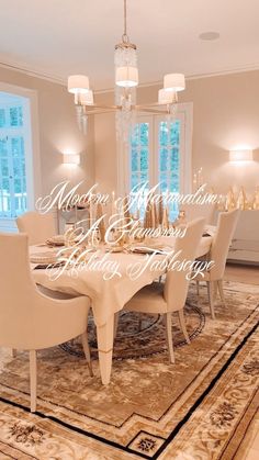 a dining room table with white chairs and a chandelier hanging from the ceiling