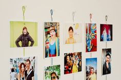 a group of pictures hanging on a wall with clothes pins attached to it's sides