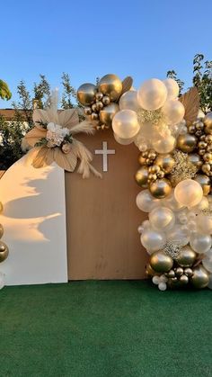 an arch decorated with balloons and flowers