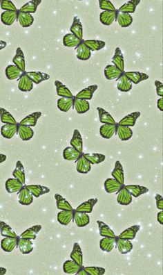 many green butterflies flying in the sky with sparkles on it's wings and back