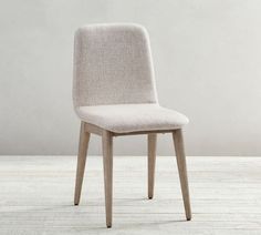 a white chair sitting on top of a wooden floor