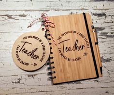 two wooden notebooks with the words teacher and an ornament attached to them