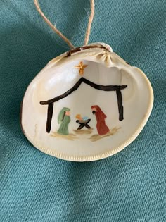 a ceramic ornament with a nativity scene on it