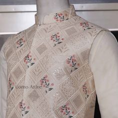 The cream waistcoat is a luxurious piece of clothing made from embroidered fabric with intricate embellishments. Its elegant design makes it perfect for special occasions. The accompanying kurta and pajama are both white and complement the waistcoat beautifully. Here are some key features of the outfit: Luxurious fabric: The waistcoat is made from high-quality embroidered fabric,giving it a rich and luxurious feel.Intricate embellishments: The waistcoat is adorned with delicate embellishments adding to its elegance and sophistication.Elegant design:The overall design of the outfit is classic and timeless, making it suitable for various formal events.Perfect for special occasions: This outfit is ideal for weddings, receptions, and other special celebrations.Comfortable and breathable: The k Elegant Embroidered Nehru Jacket For Traditional Ceremonies, Elegant Nehru Jacket With Resham Embroidery For Ceremonies, Elegant Resham Embroidery Nehru Jacket For Traditional Ceremonies, Beige Bandhgala With Intricate Embroidery, Off White Nehru Jacket With Dabka For Festive Occasions, Cream Raw Silk Nehru Jacket With Chikankari Embroidery, Cream Nehru Jacket With Chikankari Embroidery In Raw Silk, Cream Nehru Jacket With Intricate Embroidery For Diwali, Cream Nehru Jacket With Dabka And Straight Kurta Shape