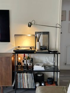 a living room with a record player and a lamp