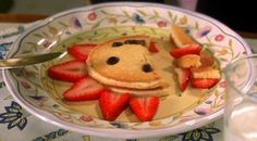 a plate with pancakes and strawberries on it