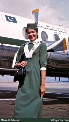 a woman standing in front of an airplane