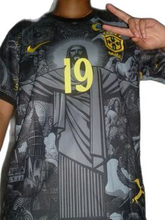 a man wearing a shirt with the number 19 on it and holding his hand up