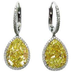 These spectacular yellow diamond earrings are like wearing drops of sunshine! This beautifully matched pair of pear shaped yellow diamonds are certified by GIA as Fancy Yellow color and VS2 clarity, and together they total 12.16 carats. A delicate micropave halo of white diamonds is the perfect contrasting frame around the yellow pears. The earrings are made in platinum, with pave adding sparkle to the wire. The yellow diamonds are set in 18K yellow gold so the prongs disappear into the diamond. Princess Diamond Earrings, Yellow Diamond Earring, Sapphire Jewellery, Colored Diamond Jewelry, Fancy Yellow Diamond, Yellow Jewelry, Leverback Earrings, Pear Diamond, Diamond Drops