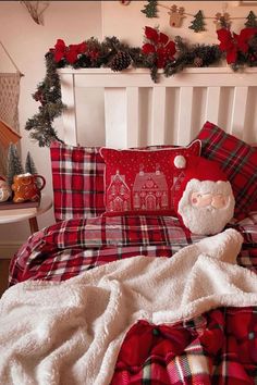 a red and white plaid bed spread with a santa clause pillow on top of it