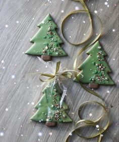 three decorated christmas trees on a table