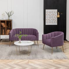 a living room with two purple chairs and a white coffee table