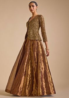 Step into elegance with Gold Embroidered Jacket Set. Crafted from luxurious blended silk, this stunning jacket features intricate zardozi and sequin embroidery detailing that exudes sophistication. The jacket's opulent design is perfectly complemented by a flared skirt, creating a harmonious blend of tradition and contemporary style. A perfect indo western outfit a bride or bride to be for Cocktail parties or Reception Night. Composition : Jacket - Blended Silk, Skirt - Tissue Care: Dry Clean On Two Piece Outfits Indian Wedding, Hand Embellished Blouse Piece For Party Wear, Party Wear Hand Embellished Blouse For Festive Season, Festive Hand Embellished Party Wear Blouse Piece, Festive Hand Embellished Party Wear Blouse, Formal Sets With Resham Embroidery For Fall, Formal Embroidered Sets For Fall, Formal Party Wear Choli With Zari Work, Evening Sets With Intricate Embroidery In Georgette