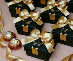 chocolates wrapped in gold ribbon are sitting on a table