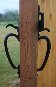 a wooden fence with two black handles on it