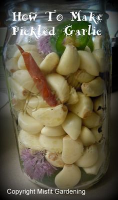 a jar full of pickled garlic with the title how to make pickled garlic