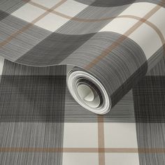 a grey and white plaid wallpaper with a roll of tape on it's side