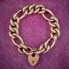 A grand antique Victorian curb bracelet made up of chunky 9ct gold links that have developed a lovely golden-bronze patina with age. The smallest links have been engraved with textured patterning across the top and contrast beautifully against four larger links in between. It's all held by a safety chain and heart padlock clasp which were often gifted by Victorian gentlemen to their loved ones during long periods of separation, as a symbol of the couple's strong commitment to one another.  It's Victorian Gentleman, Bracelet With Heart, Heart Padlocks, Antique Bracelets, Bronze Patina, Turquoise Ring Silver, Simple Bracelets, Safety Chain, Pink Topaz