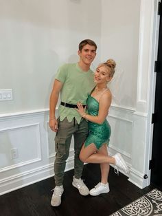 a man and woman dressed up as tinkerbells pose for a photo together